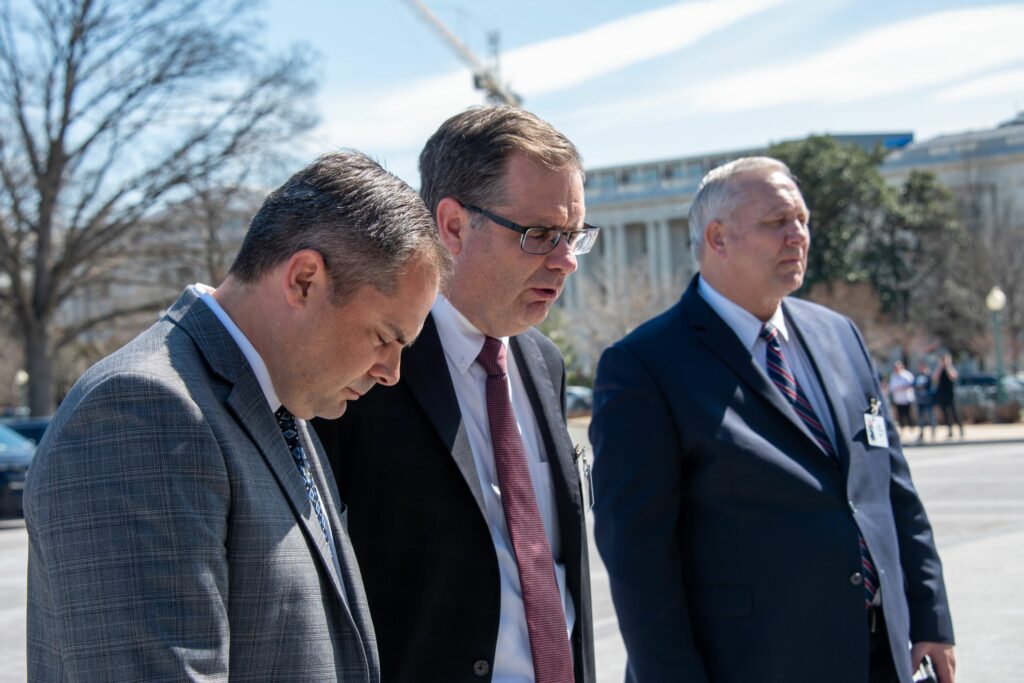 Brad Cranston prays with Congressman Mike Garcia at the Capitol steps