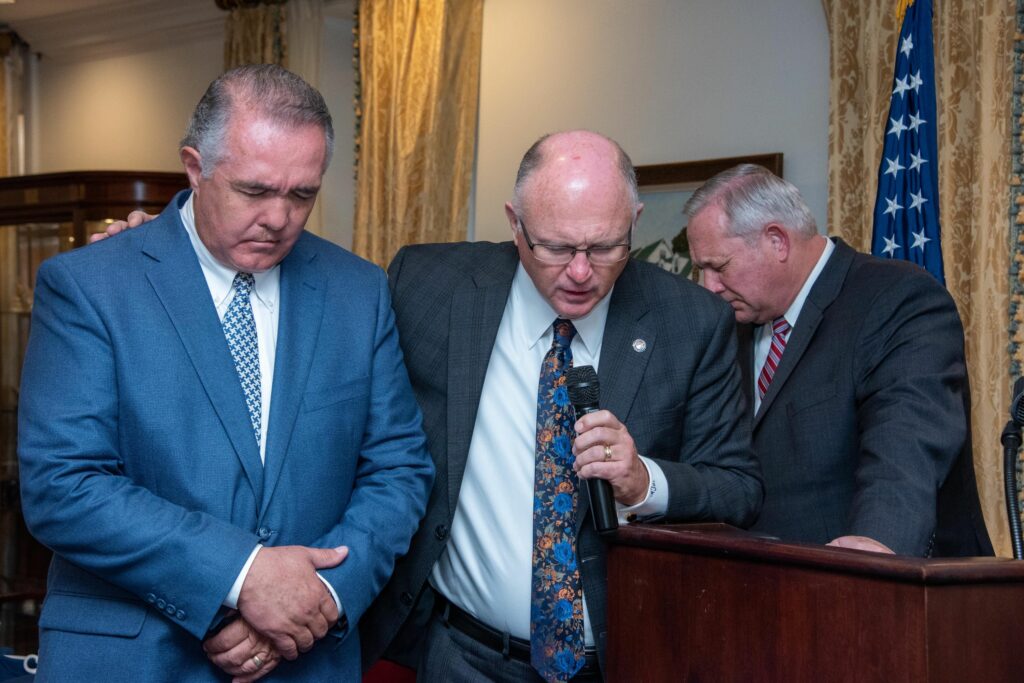 Pastor Paul Chappell prays with Congressman Trent Franks